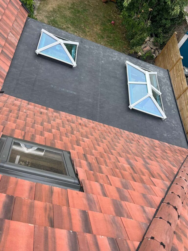 This is a photo taken from the roof ridge looking down a tiled pitched roof on to a flat roof. Works carried out by TRP Roofing Sutton-on-Hull
